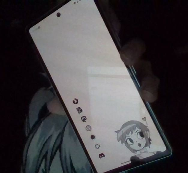 Riley's smartphone held at a distance showing the home screen. It's mostly black and white with a drawing of Ramona Flowers and no notificaitons.