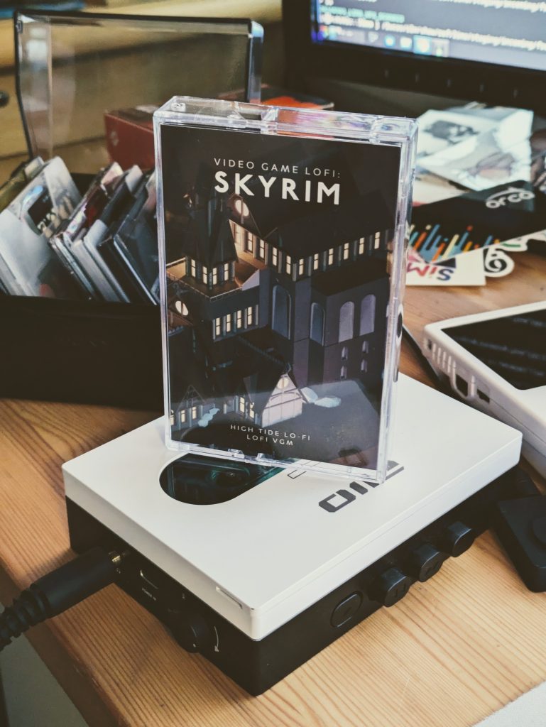 The FIIO CP13 cassette player in white, with a "Lofi Skyrim" cassette on top of it.