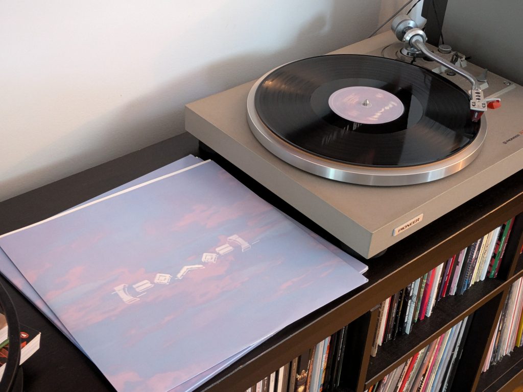 Riley's grey turntable of choice, the Pioneer PL-514, currently playing Worlds by Porter Robinson.